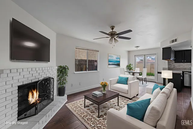 a living room with furniture a fireplace and a flat screen tv