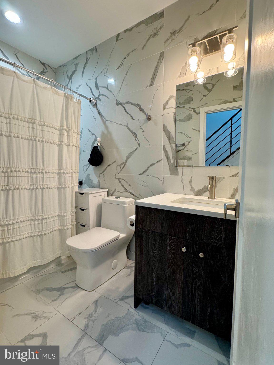1217 LeCount Street Philadelphia, PA 19121 - Photo 20 of 29 Sleek modern bathroom with elegant tiles.