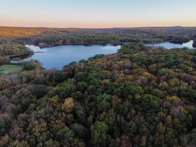 an aerial view of residential houses with outdoor space and river