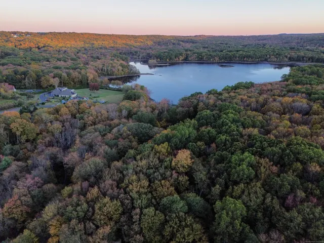 an aerial view of a houses with outdoor space and river
