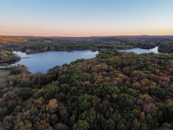 an aerial view of a houses with a lake