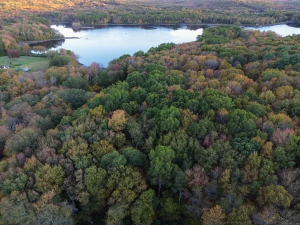 an aerial view of a houses with outdoor space and lake view