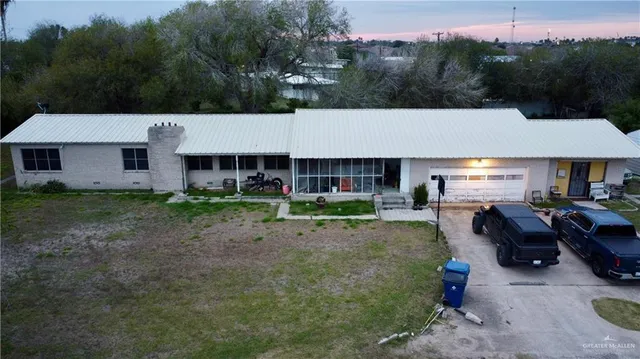 a view of a house with backyard porch and sitting area