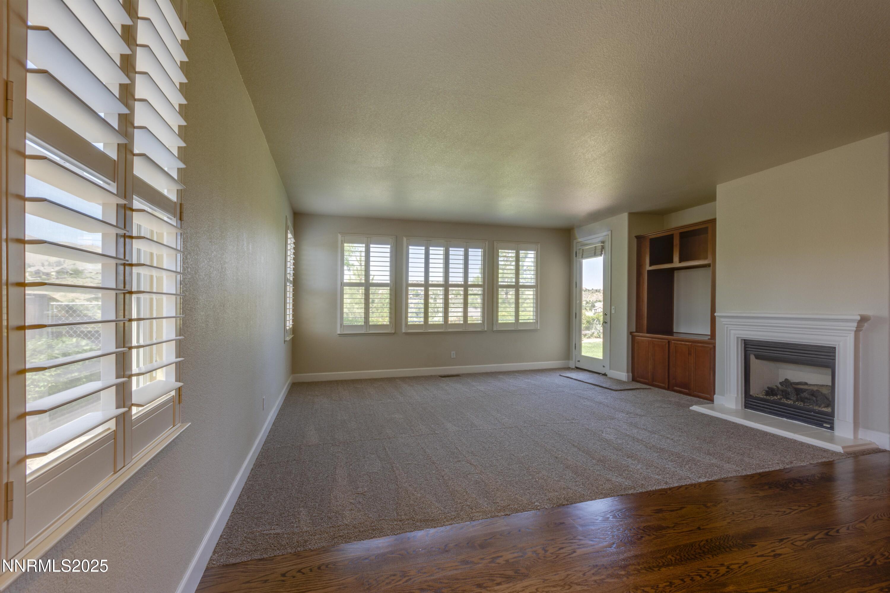 1798 Evening Rock Court Reno, NV 89523 - Photo 12 of 27 a view of an empty room with a window and fireplace