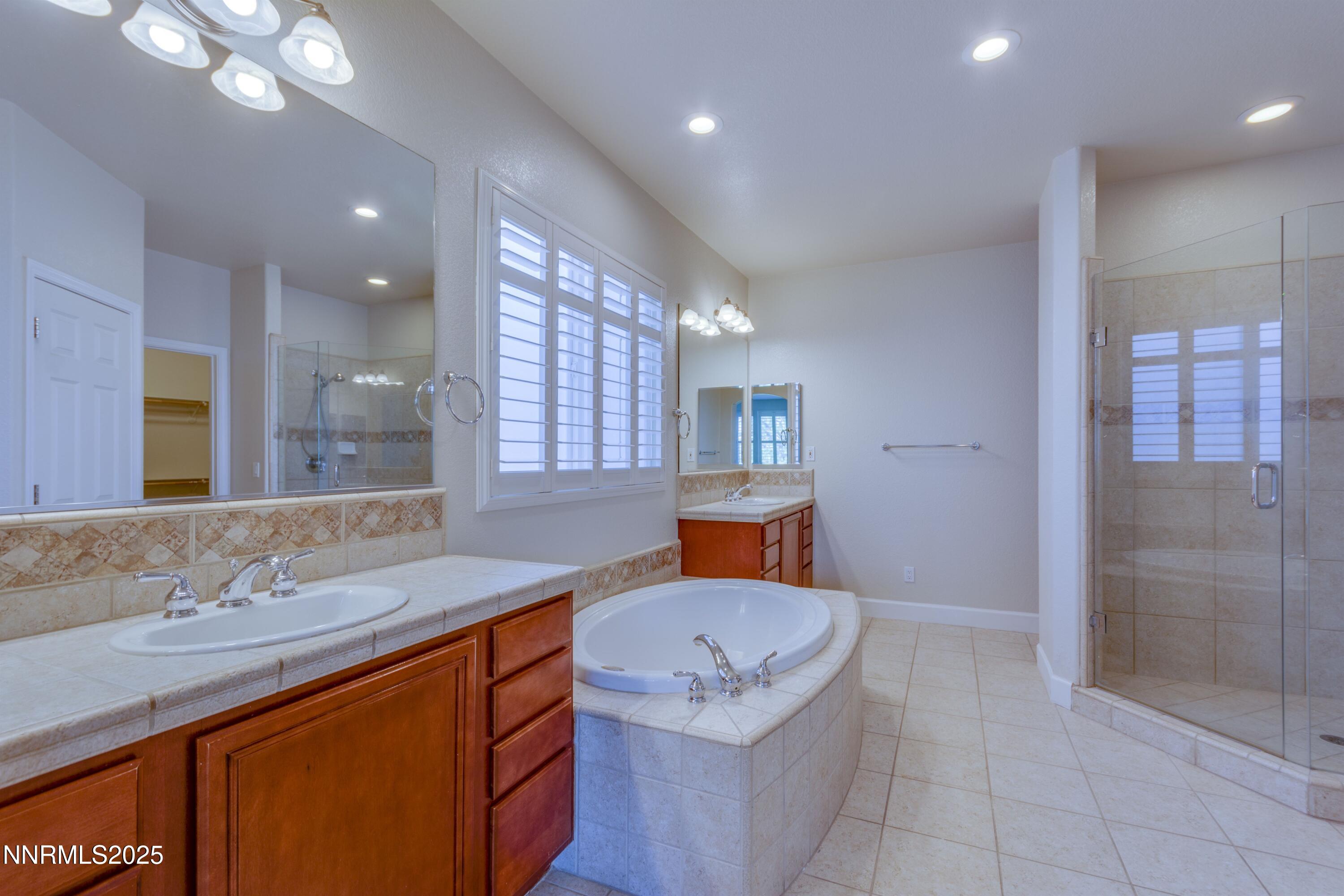 1798 Evening Rock Court Reno, NV 89523 - Photo 16 of 27 a bathroom with a sink a tub and a mirror