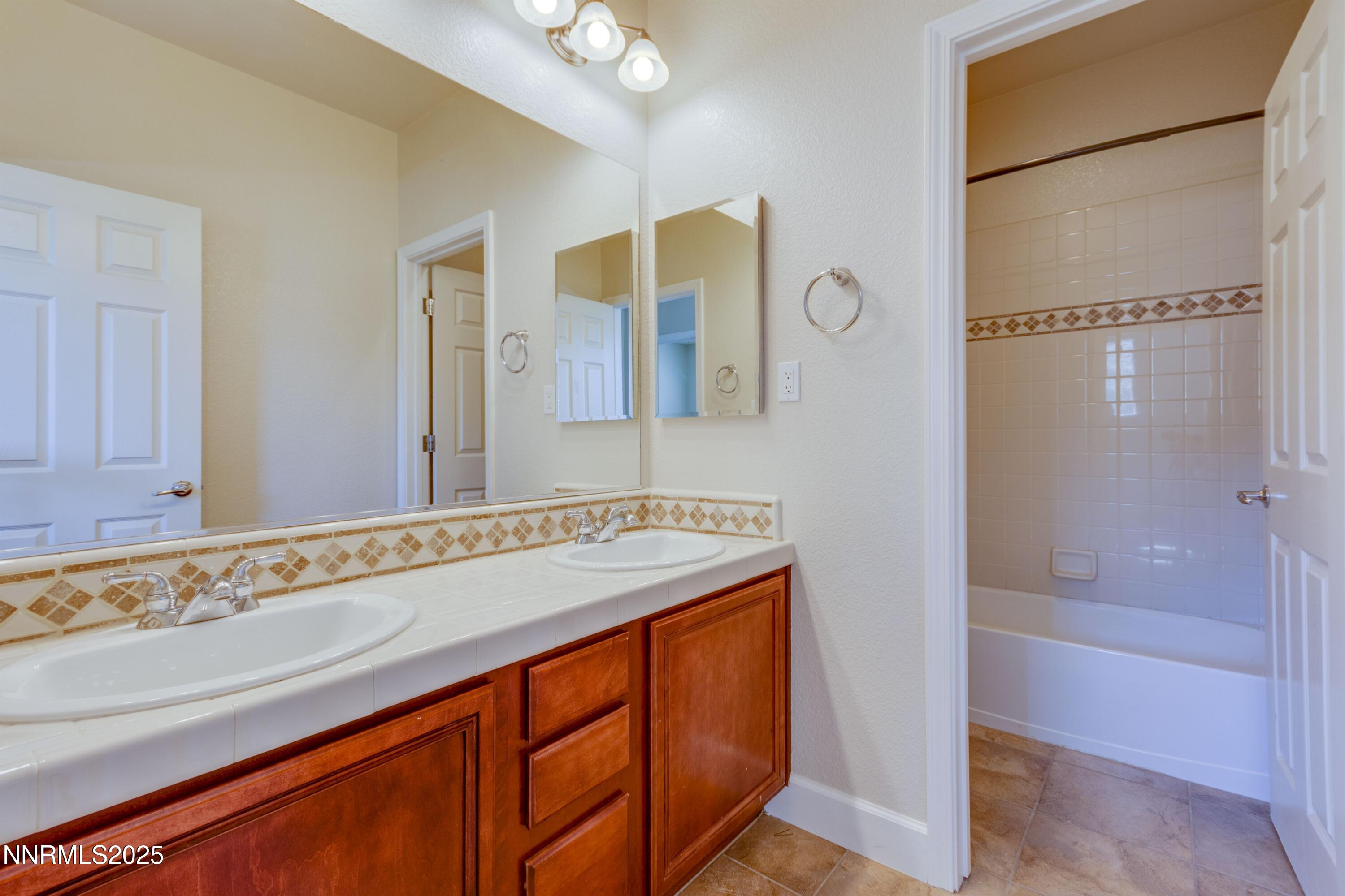 1798 Evening Rock Court Reno, NV 89523 - Photo 21 of 27 a bathroom with a granite countertop sink and a shower