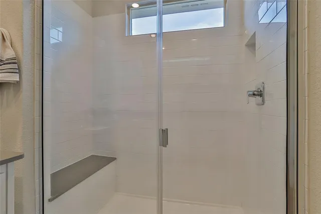 a bathroom with a shower sink and mirror