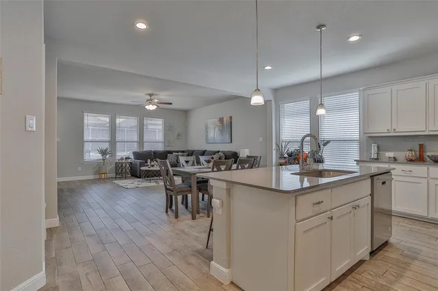 a kitchen with sink cabinets and dining table
