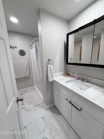 a bathroom with a sink a toilet and a mirror