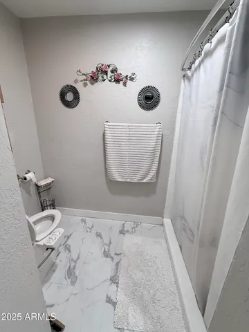 a bathroom with a tub and shower