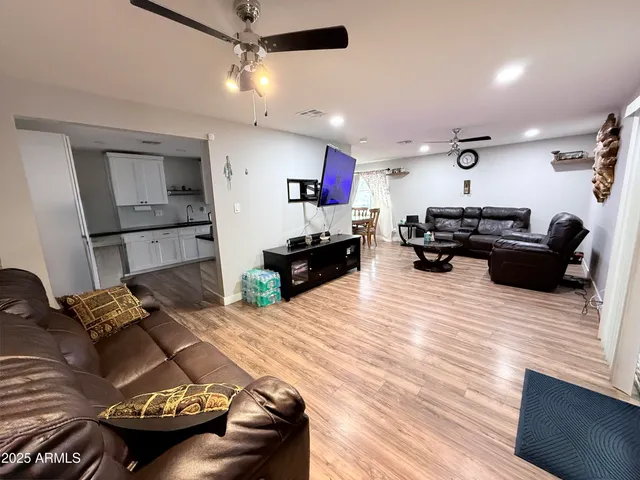 a living room with furniture and a wooden floor