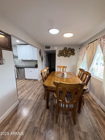 a view of a dining room with furniture and wooden floor