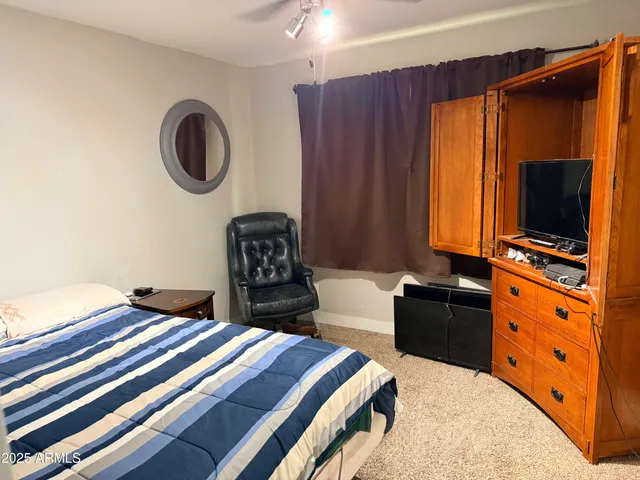 a bedroom with a bed and a television