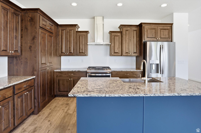 3636 West 910 South Syracuse, UT 84075 - Photo 33 of 70 Modern kitchen featuring a contrasting blue island base, granite countertops, and wood-finish flooring