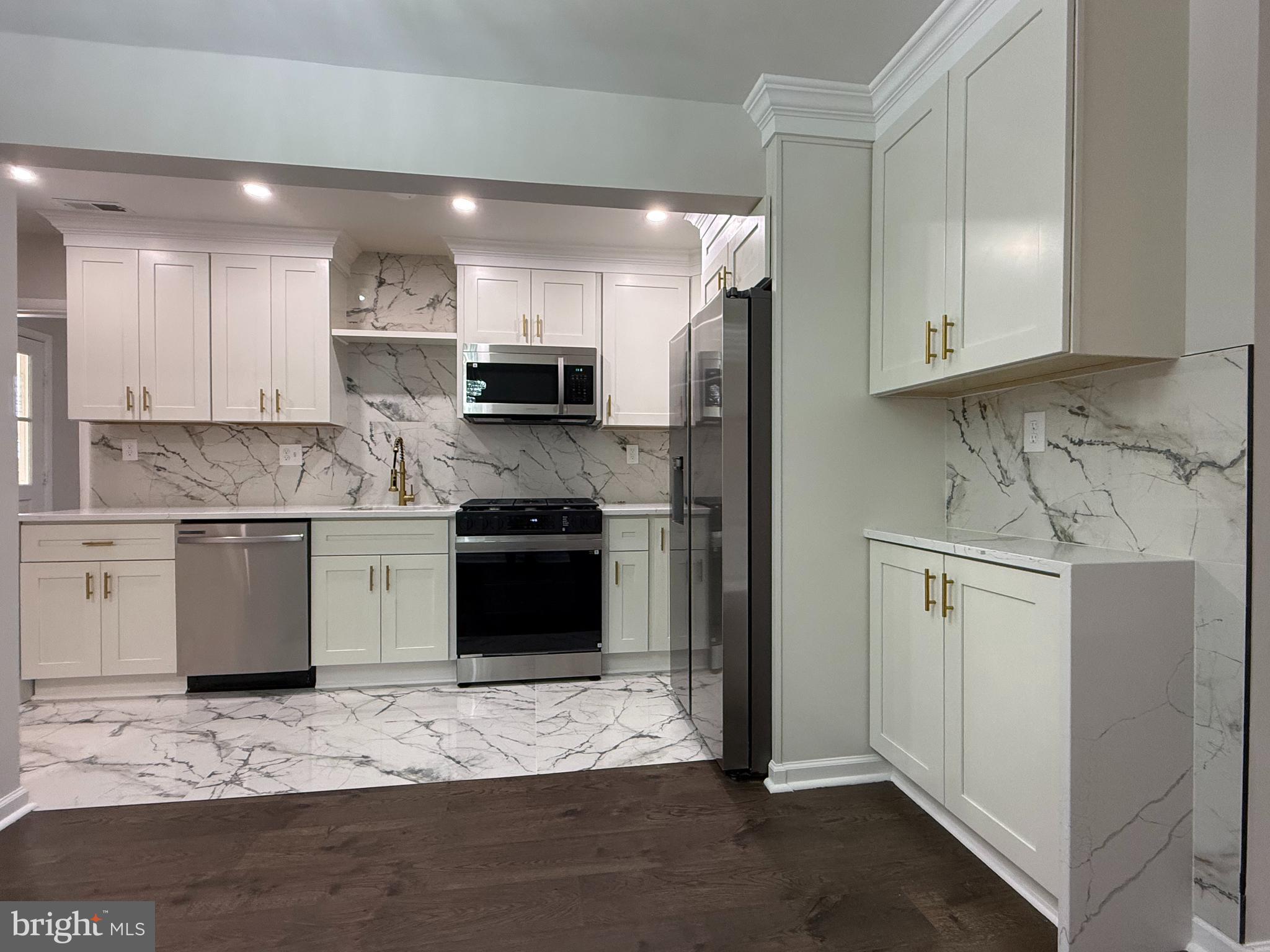 1203 Riggs Court Woodbridge, VA 22191 - Photo 22 of 39 a kitchen with stainless steel appliances granite countertop a refrigerator sink and cabinets