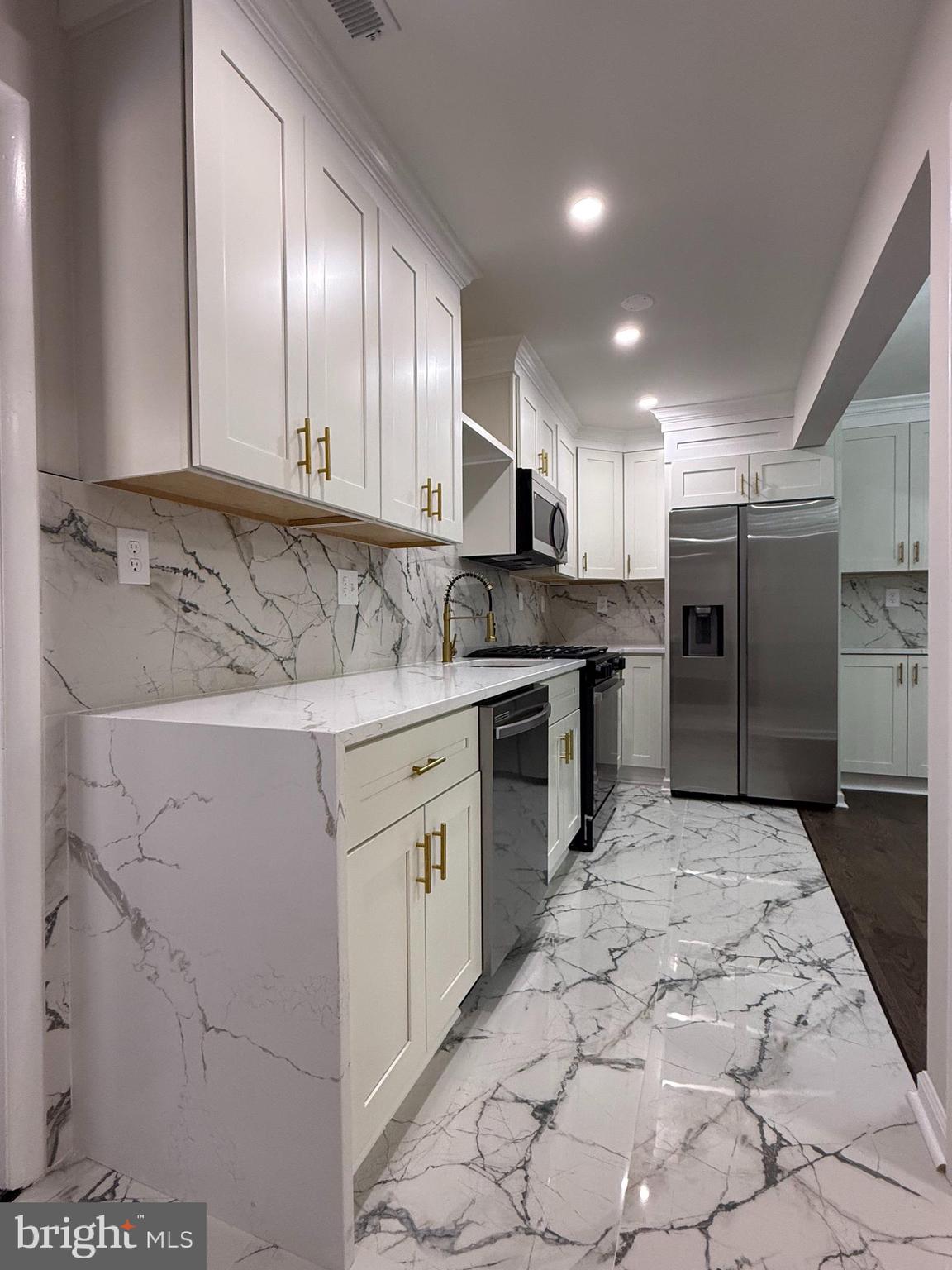1203 Riggs Court Woodbridge, VA 22191 - Photo 24 of 39 a kitchen with stainless steel appliances granite countertop a stove a sink and a refrigerator