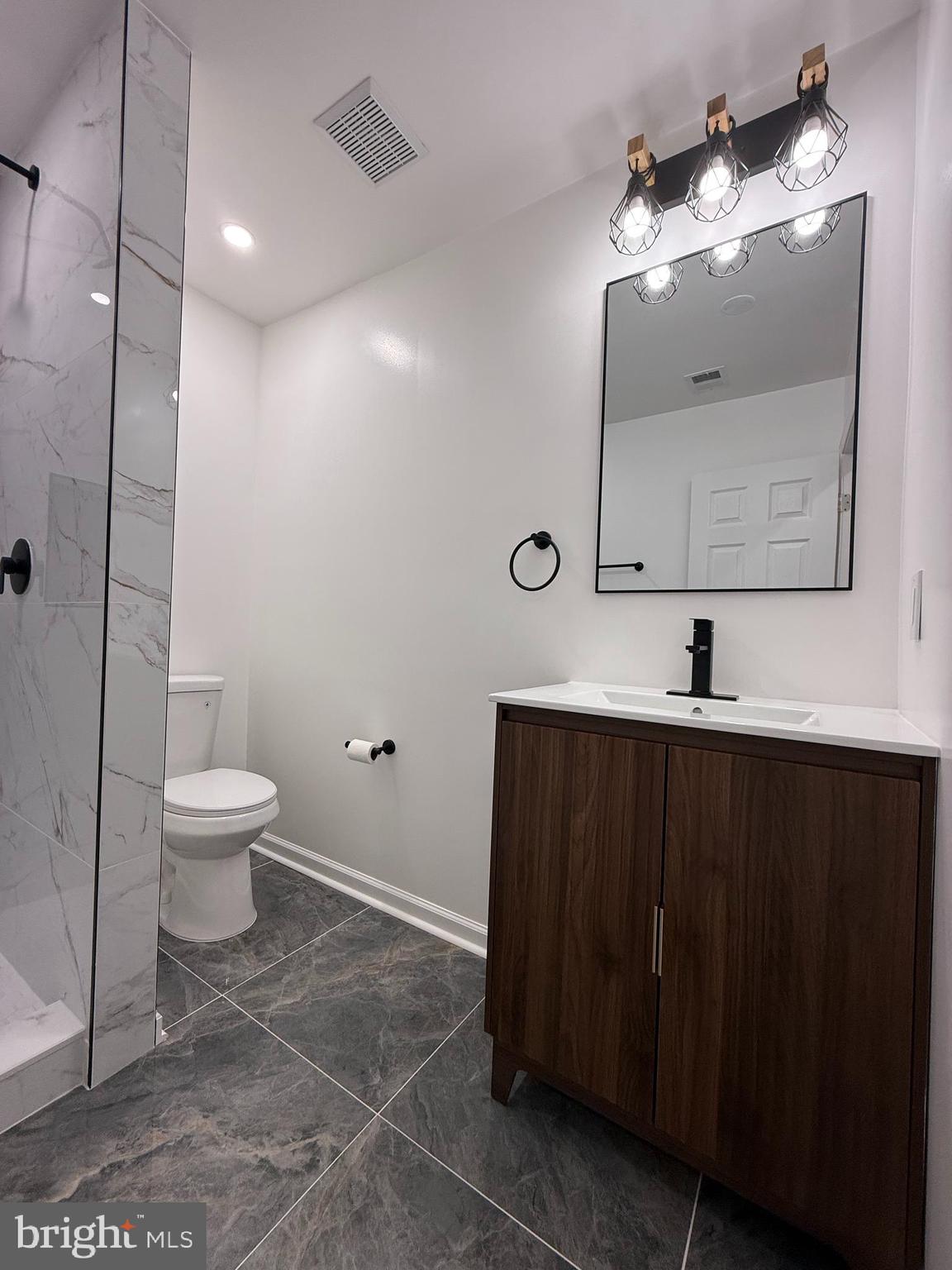 1203 Riggs Court Woodbridge, VA 22191 - Photo 36 of 39 a bathroom with a toilet sink and mirror