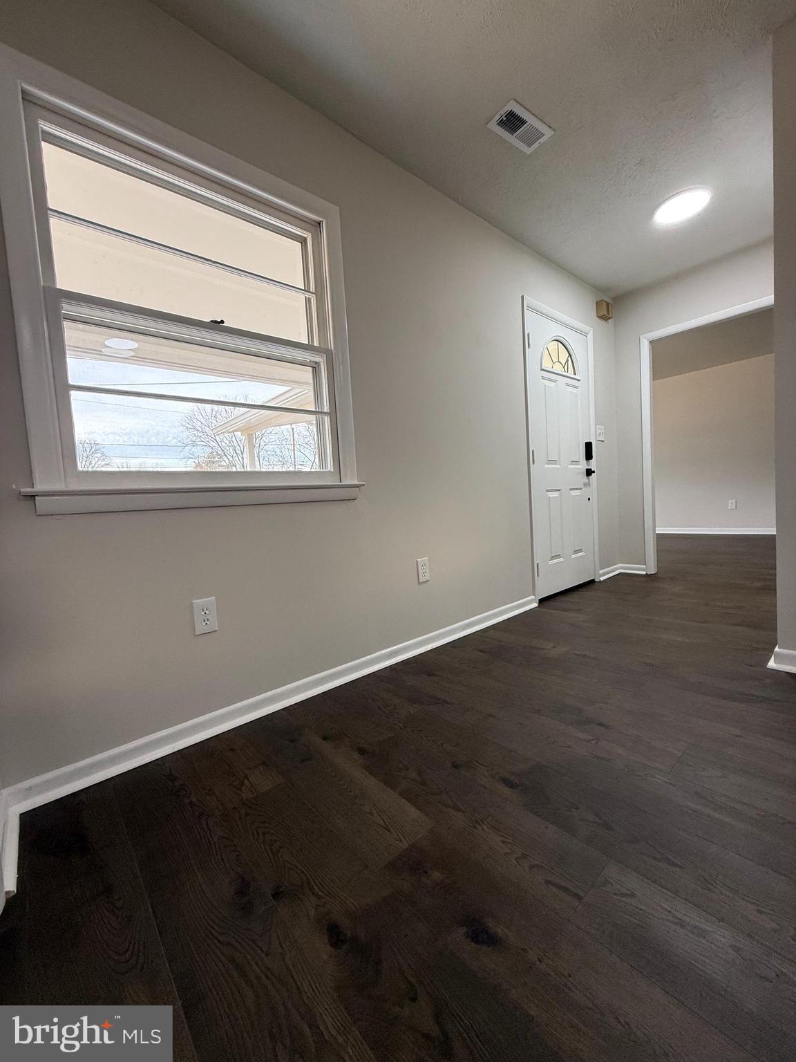 1203 Riggs Court Woodbridge, VA 22191 - Photo 38 of 39 a view of an empty room with wooden floor and a window