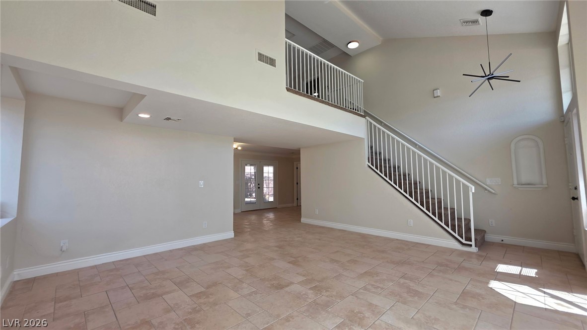 2155 Athol Way Laughlin, NV 89029 - Photo 5 of 19 A spacious entry showcases soaring ceilings, an open staircase, and durable tile flooring throughout.