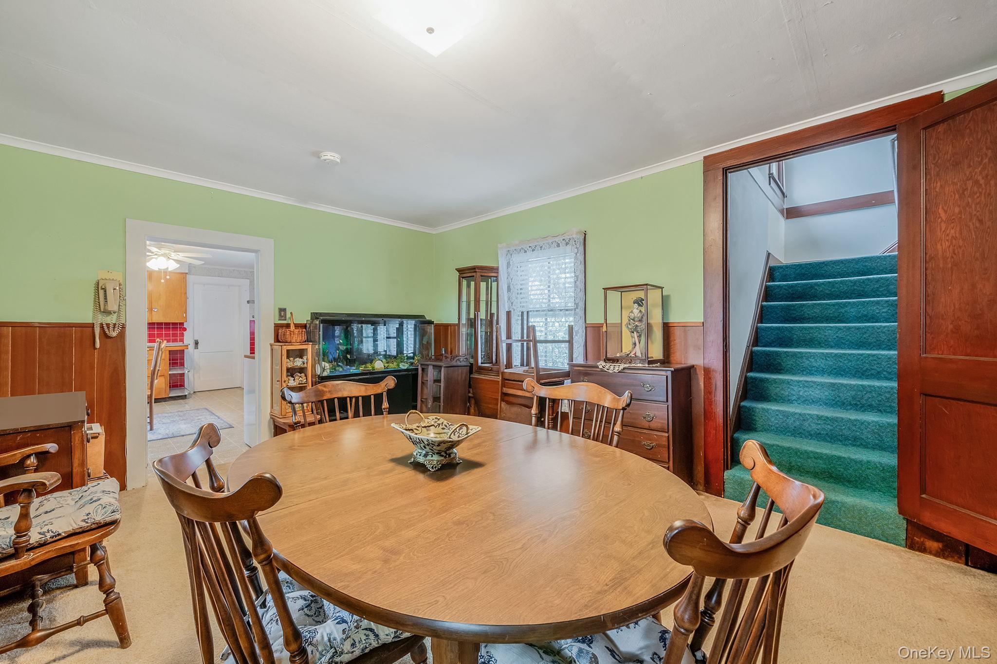 1055 Oregon Road Mattituck, NY 11952 - Photo 13 of 33 Dining area featuring wood-finish wainscoting,, and carpeting