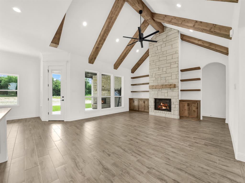 143 Desperado Way Weatherford, TX 76088 - Photo 13 of 36 Kitchen with a sink, a ceiling fan, a center island with sink, recessed lighting, and a fireplace
