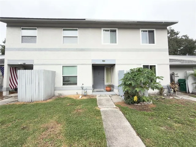 a front view of a house with a garden and plants