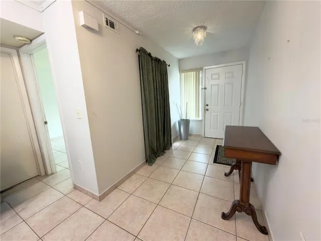 a view of hallway with furniture and a refrigerator
