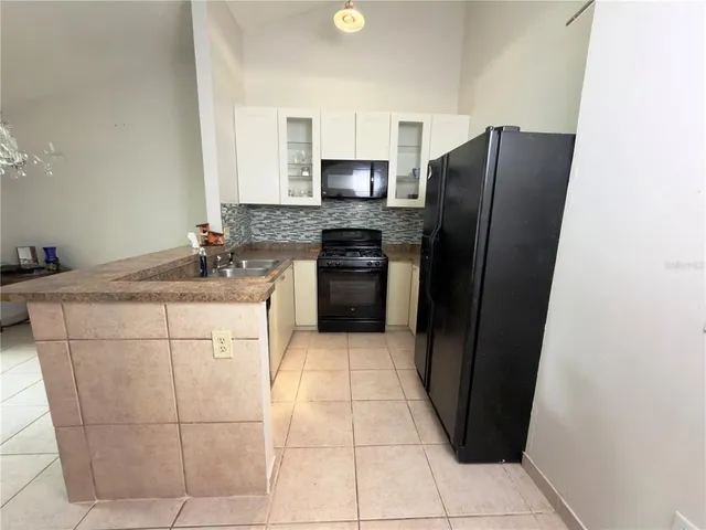 a kitchen with stainless steel appliances a refrigerator sink and microwave