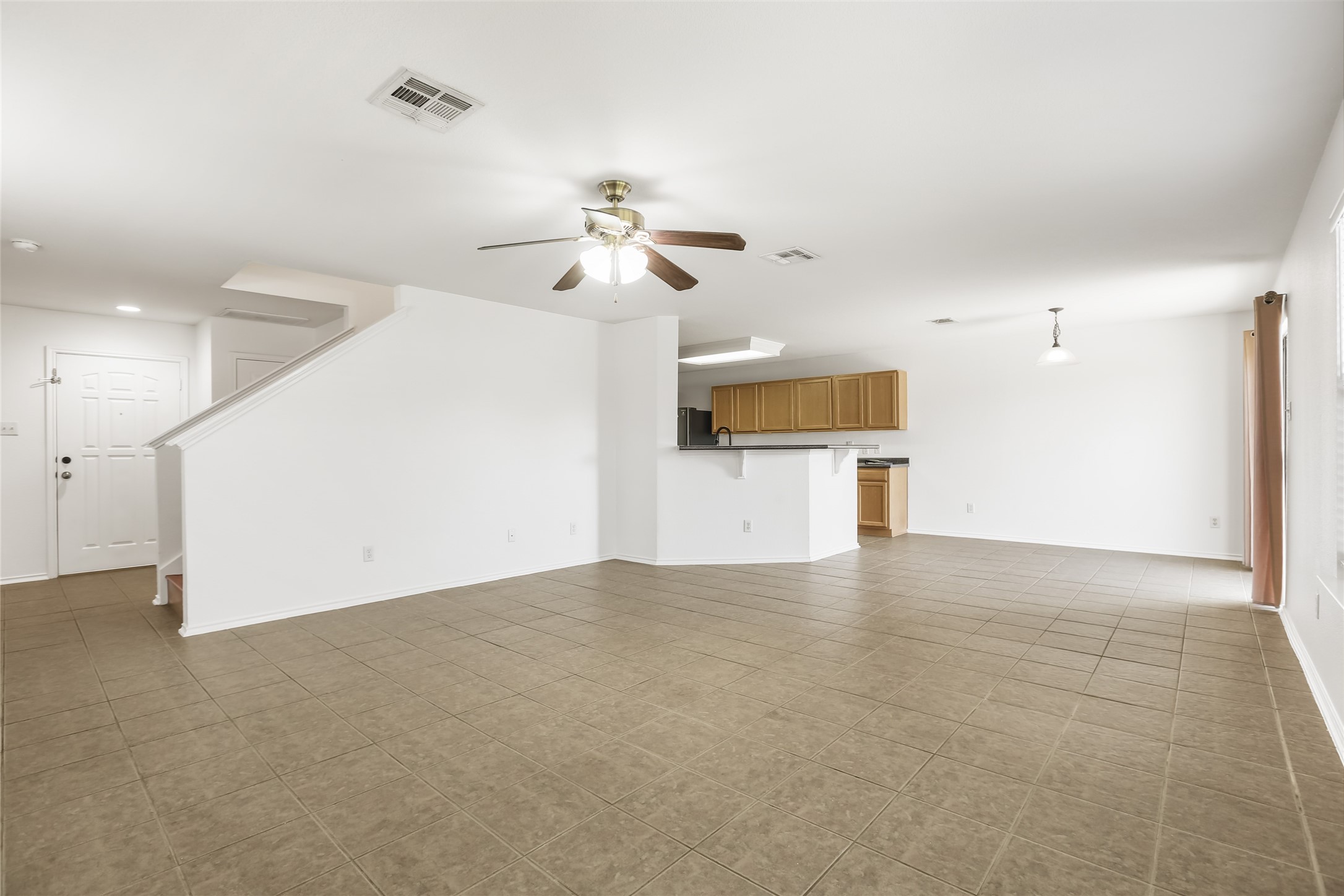 2010 Ashberry Trail Georgetown, TX 78626 - Photo 3 of 24 Unfurnished living room featuring ceiling fan and dark tile patterned floors
