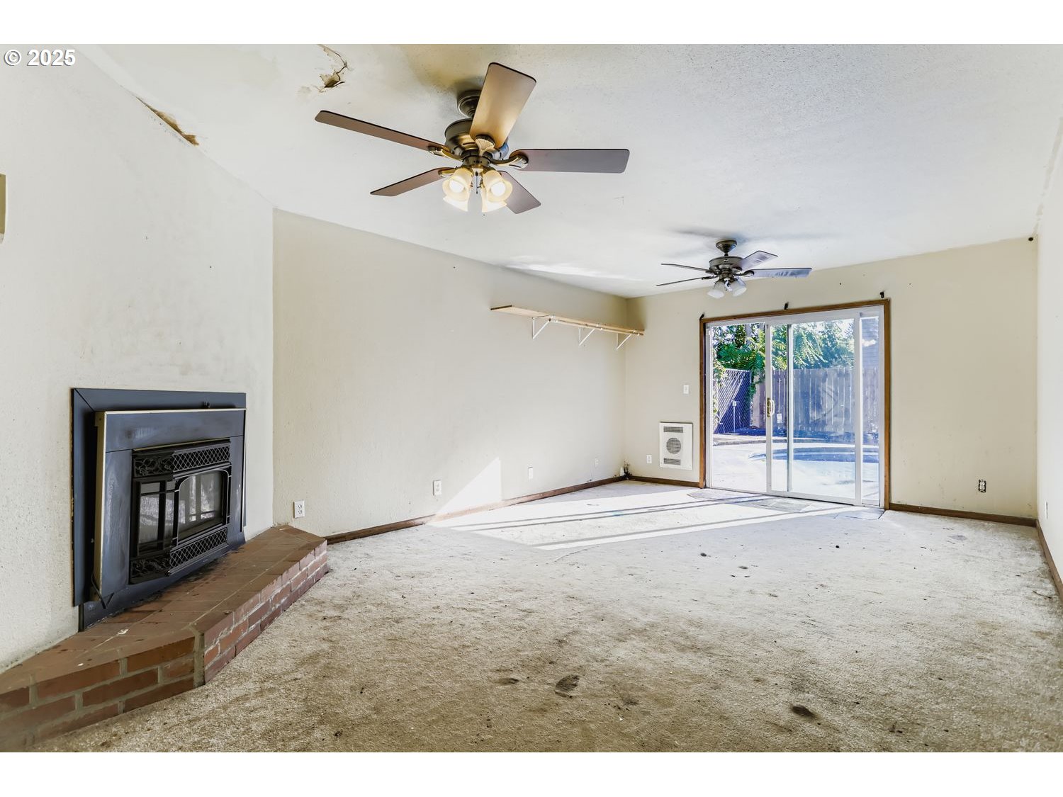 6524 Southeast 86th Avenue Portland, OR 97266 - Photo 16 of 30 a view of an empty room with window and chandelier fan