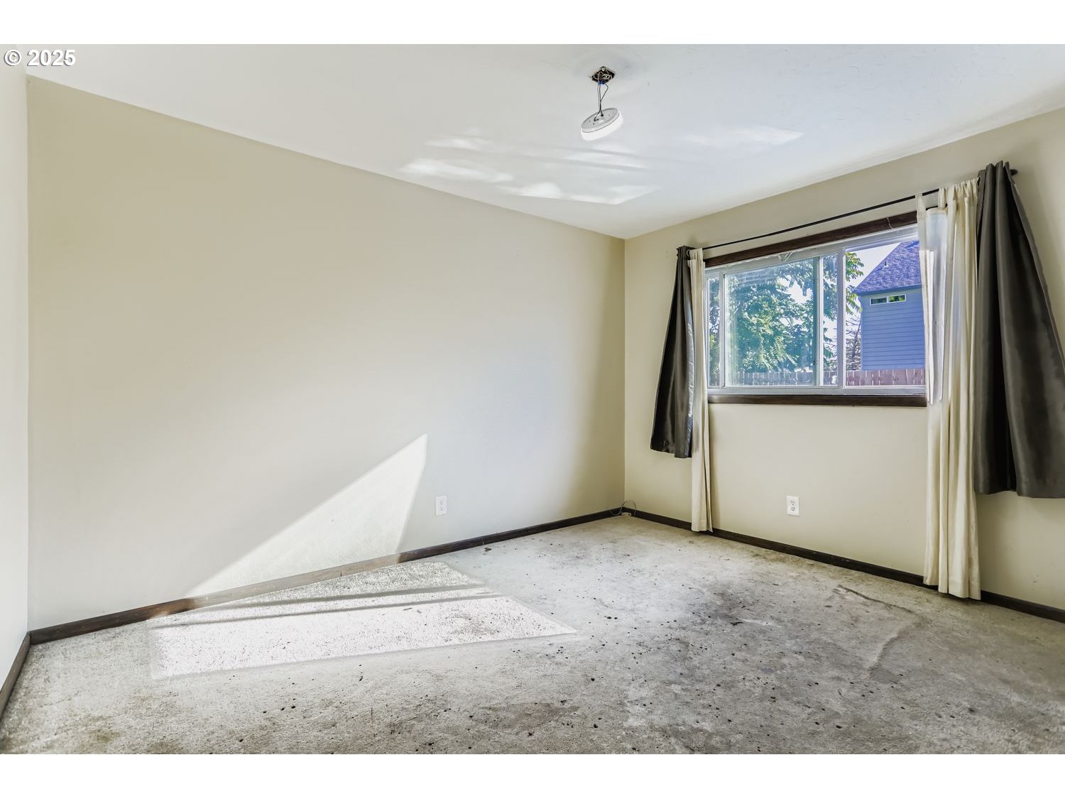 6524 Southeast 86th Avenue Portland, OR 97266 - Photo 23 of 30 a view of an empty room with wooden floor and a window