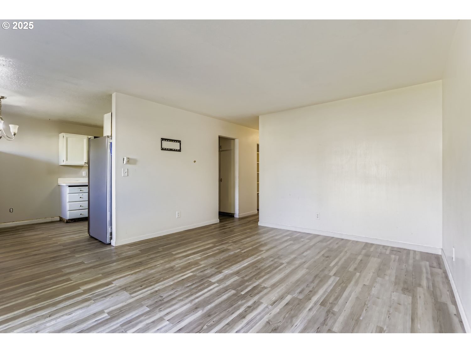 6524 Southeast 86th Avenue Portland, OR 97266 - Photo 8 of 30 a view of an empty room with wooden floor