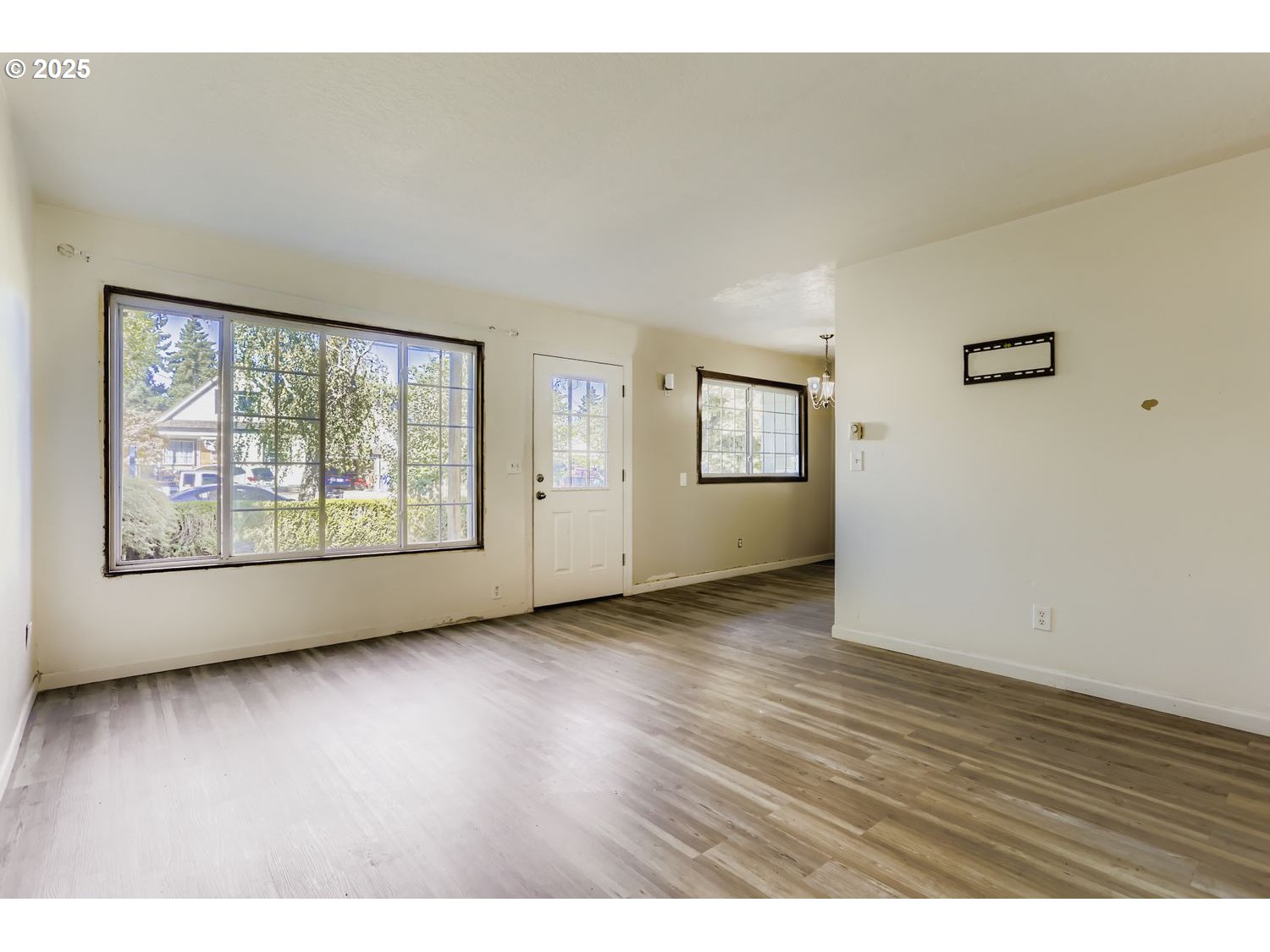 6524 Southeast 86th Avenue Portland, OR 97266 - Photo 9 of 30 an empty room with wooden floor and windows