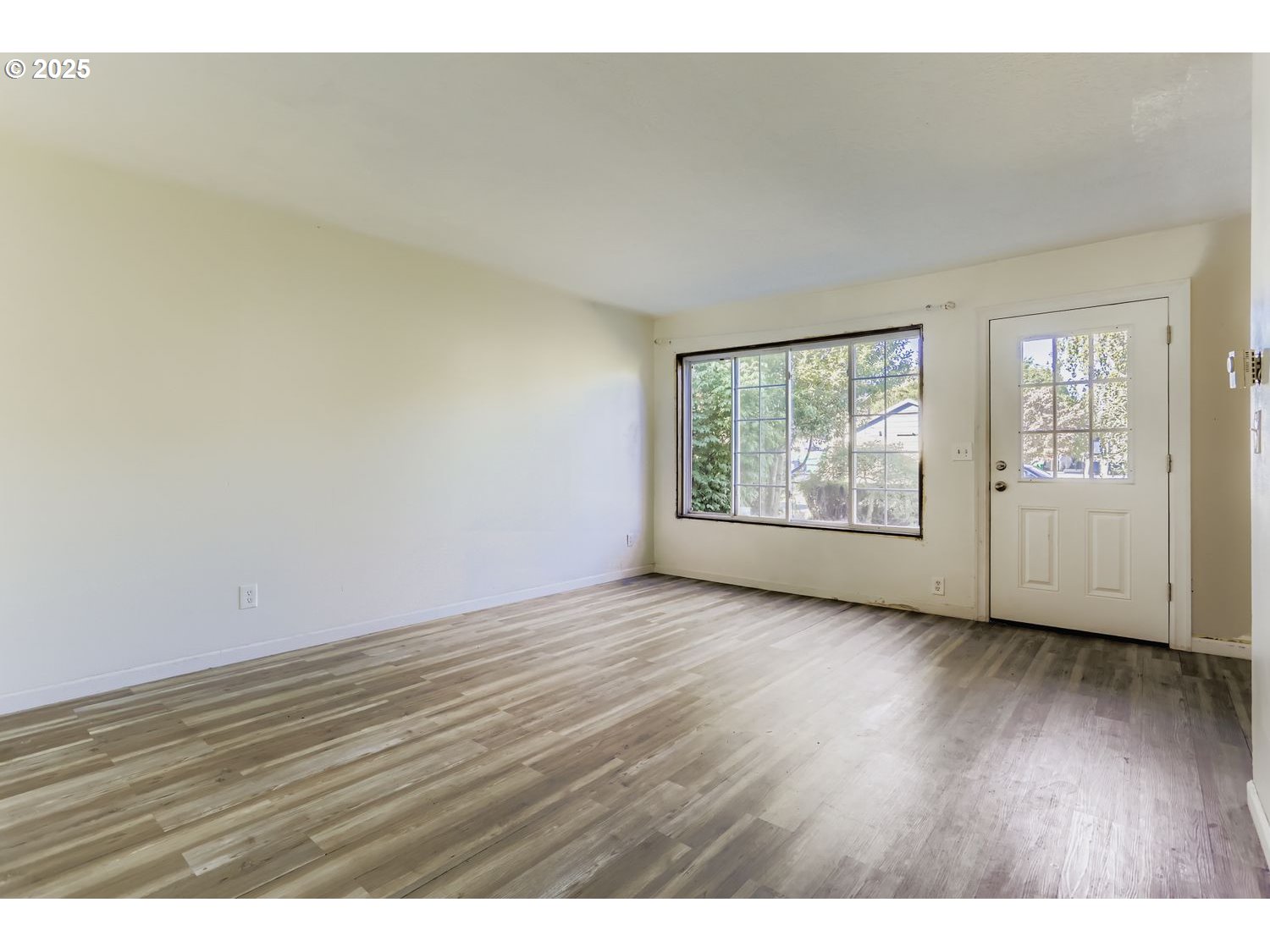 6524 Southeast 86th Avenue Portland, OR 97266 - Photo 10 of 30 an empty room with wooden floor and windows