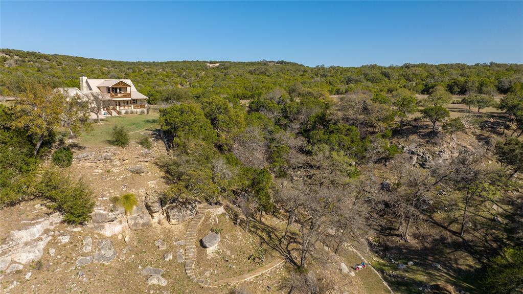 5255 Lookout Ridge Drive Marble Falls, TX 78654 - Photo 15 of 40 Aerial of home rear with stone steps and walkway, terraces, retaining wall, down canyon