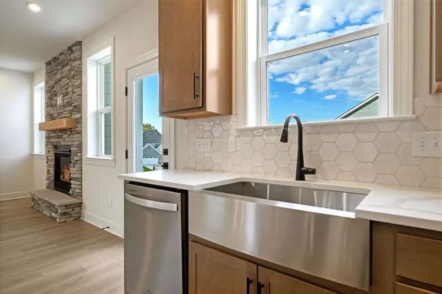 a kitchen with stainless steel appliances a sink and cabinets