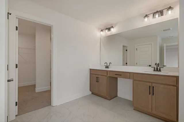 a bathroom with a double vanity sink mirror and double
