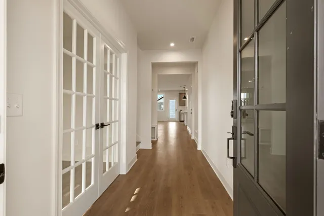 a view of a hallway with a wooden door