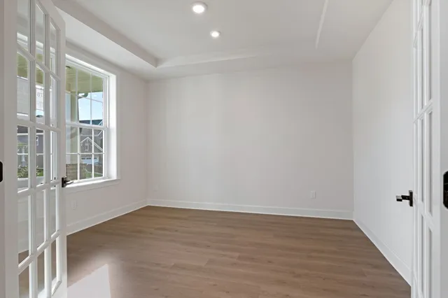 wooden floor in an empty room with a window