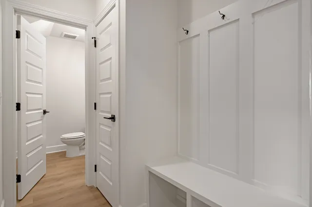 a bathroom with a granite countertop sink a toilet and shower