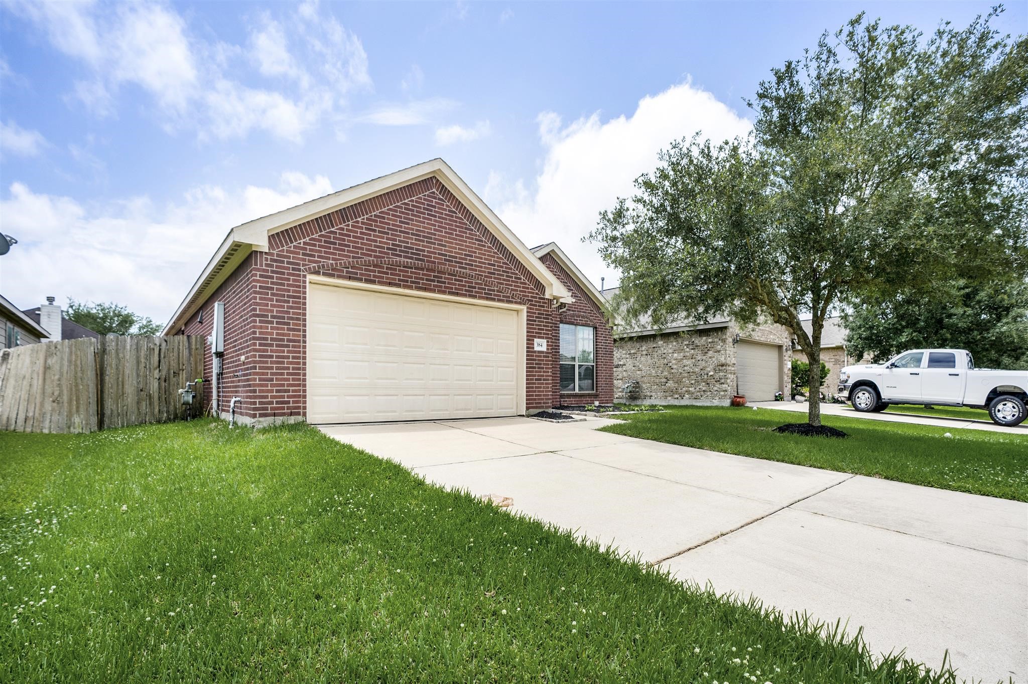 384 Decoster Boulevard Alvin, TX 77511 - Photo 2 of 27 a front view of a house with a yard and garage