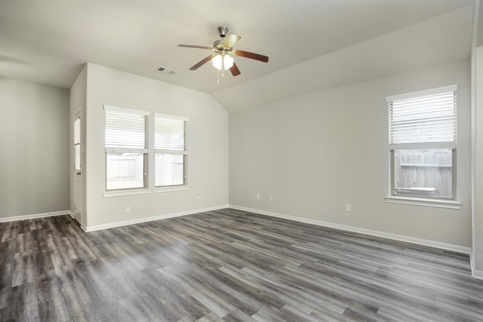 384 Decoster Boulevard Alvin, TX 77511 - Photo 9 of 27 a view of an empty room with wooden floor and a window