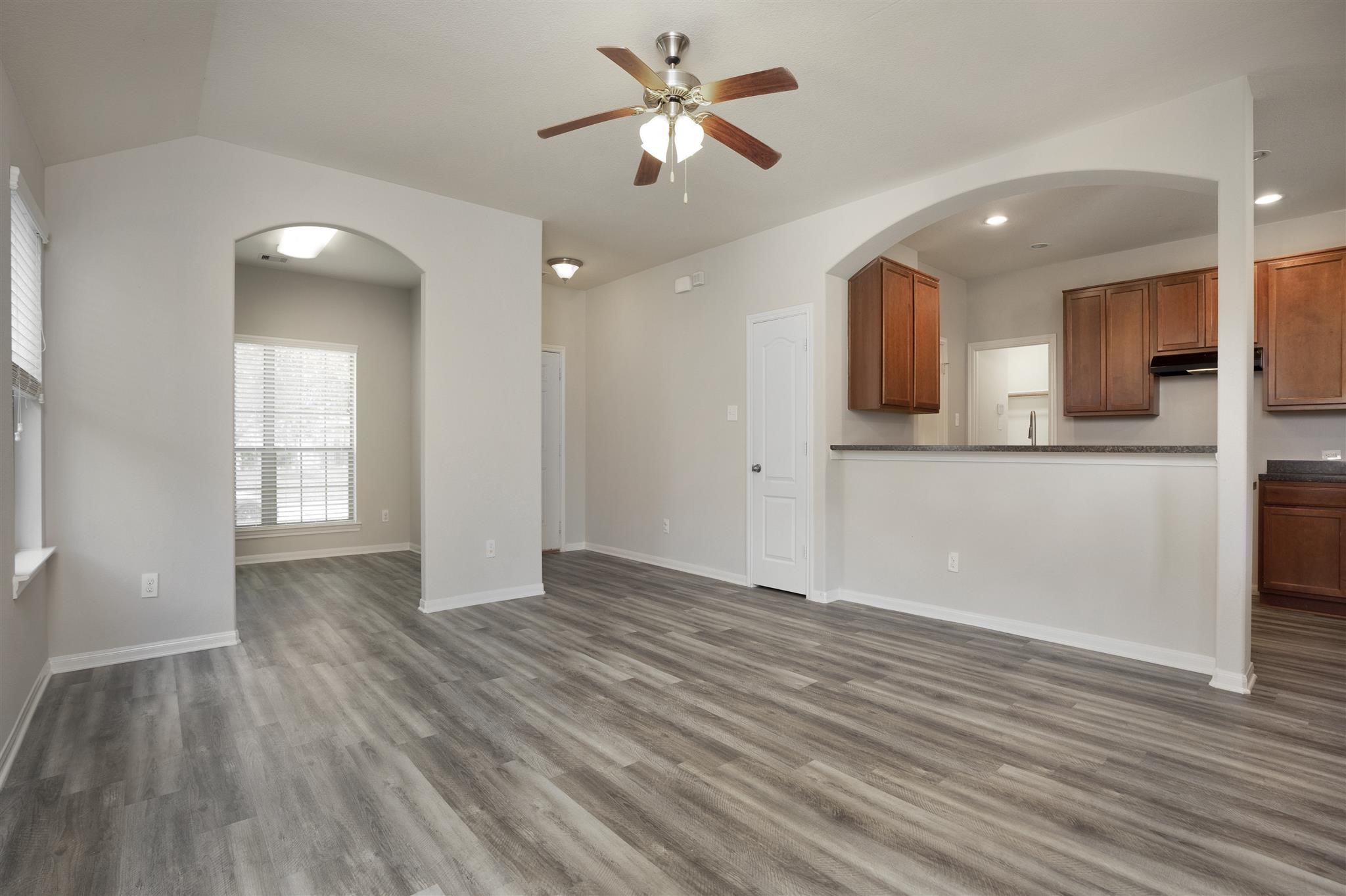 384 Decoster Boulevard Alvin, TX 77511 - Photo 10 of 27 a view of a kitchen with wooden floor and a ceiling fan