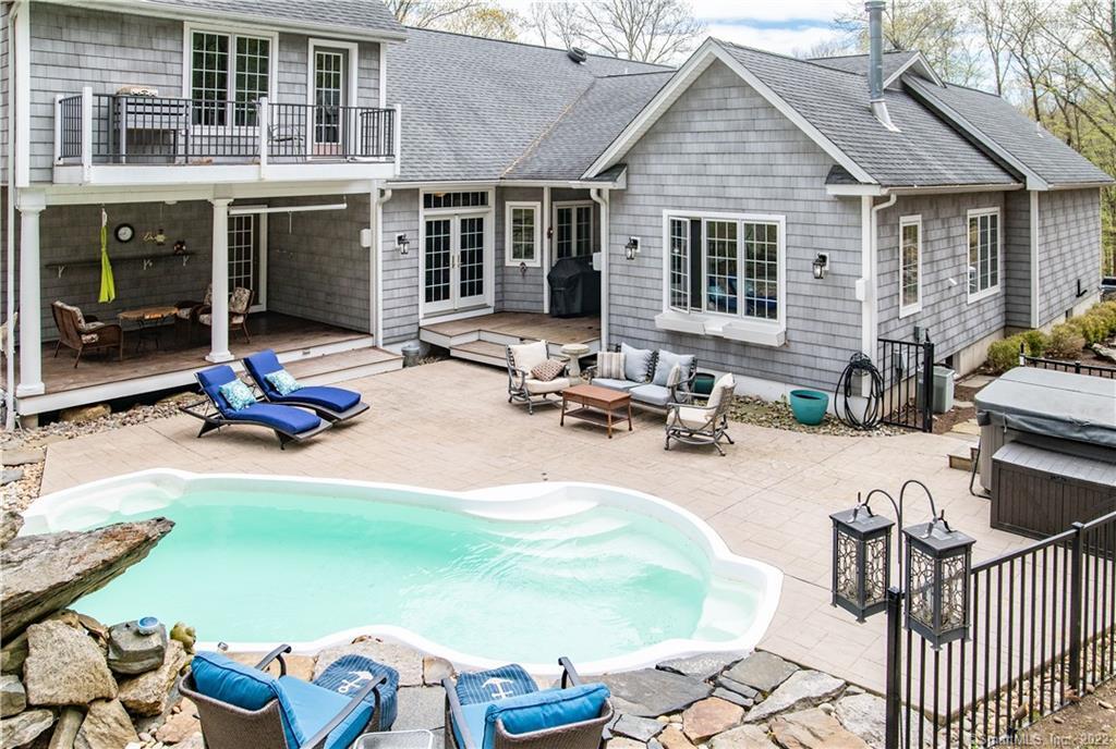 Resort like setting with a heated pool, waterfall, beautiful rocky landscape and a hot tub.