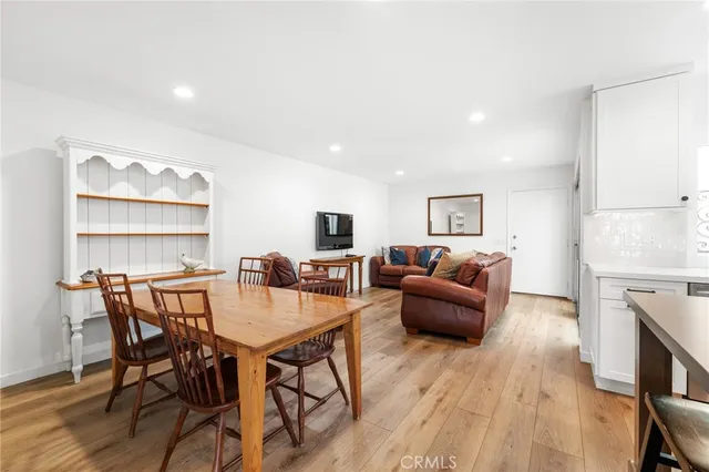 a living room with furniture a fireplace and wooden floor