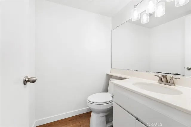 a bathroom with a sink a toilet and vanity