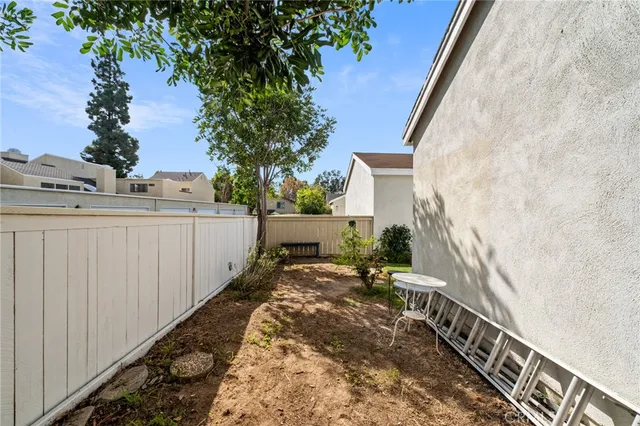 a view of a house with lots of trees and plants