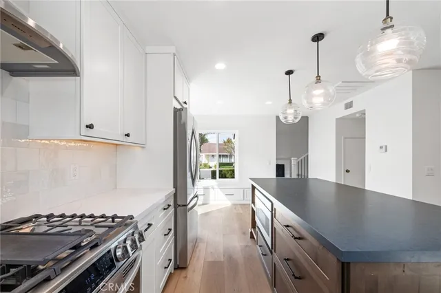 a kitchen with granite countertop a stove and a sink
