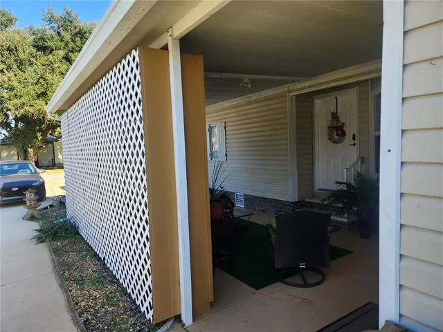 a view of a house with a yard and sitting area