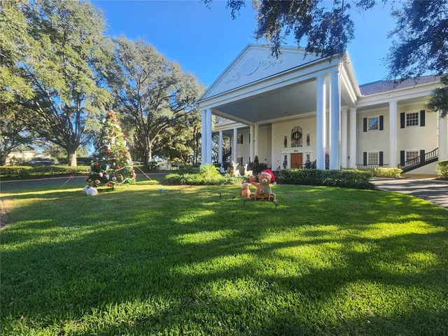 a view of a house with backyard and sitting area